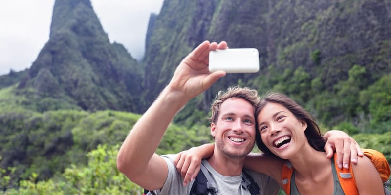 Hikers taking a selfie in front of ʻIao Needle